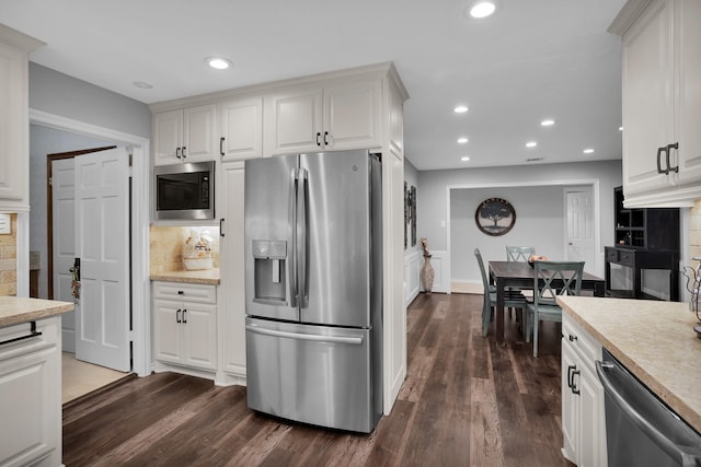 kitchen with light countertops, dark wood-style floors, and stainless steel appliances
