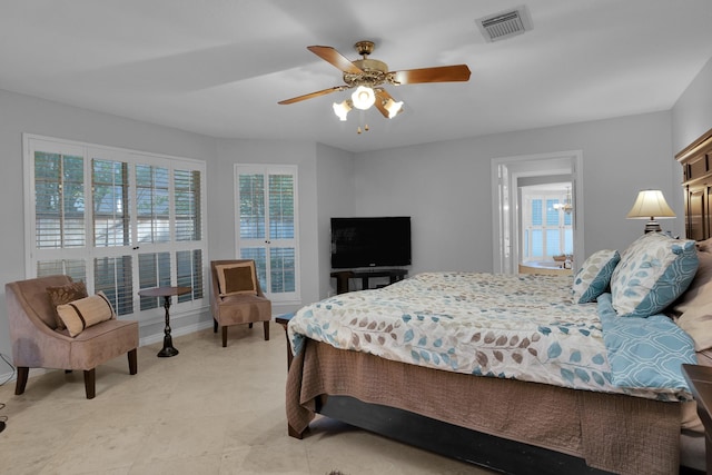 bedroom with visible vents, baseboards, ceiling fan, and multiple windows