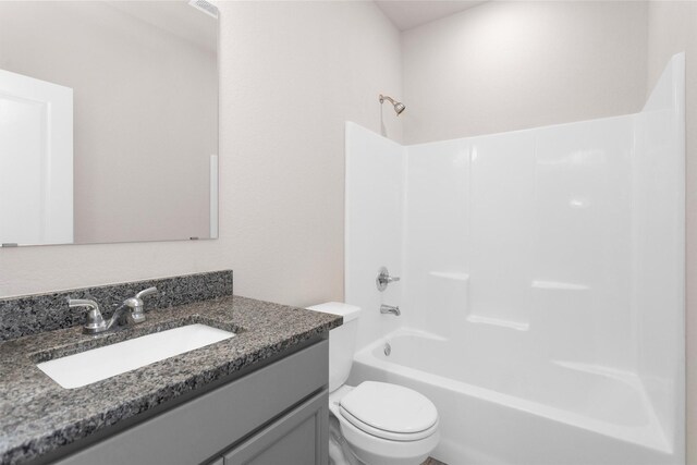 full bathroom with vanity, tub / shower combination, and toilet