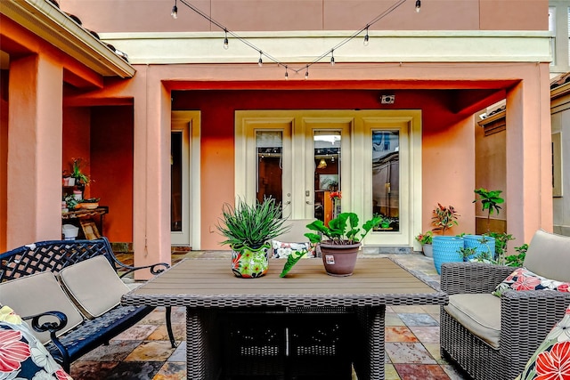 exterior space with french doors, outdoor dining area, and stucco siding