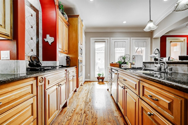 kitchen with crown molding, light wood-style flooring, a wealth of natural light, and stainless steel appliances