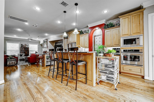 kitchen featuring crown molding, visible vents, and stainless steel appliances