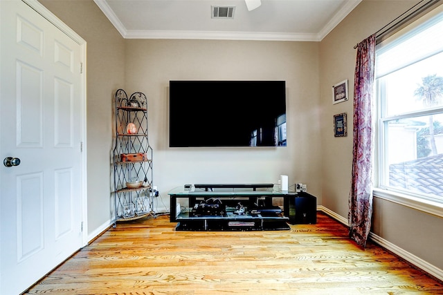 living room with visible vents, ornamental molding, plenty of natural light, and wood finished floors