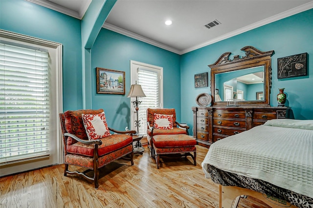 bedroom with visible vents, recessed lighting, crown molding, and wood finished floors