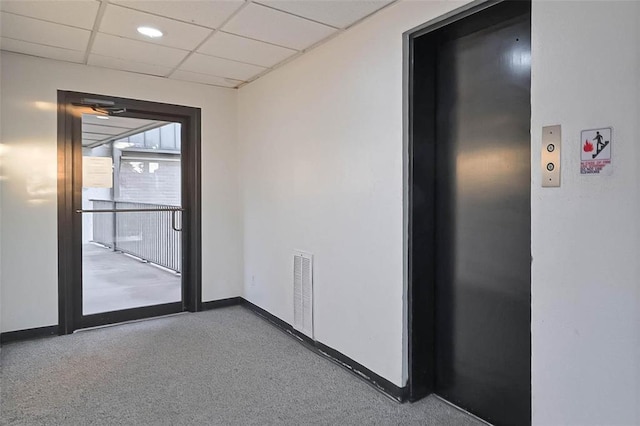 3045 Walnut Bend Ln Unit 27, Houston, TX 77042 - interior space featuring a paneled ceiling, visible vents, baseboards, elevator, and carpet flooring