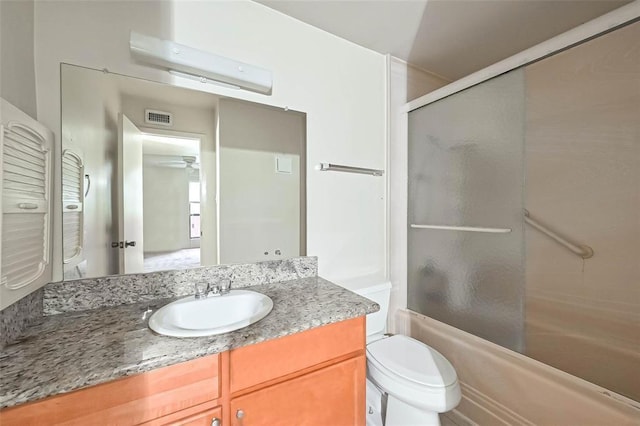 3045 Walnut Bend Ln Unit 27, Houston, TX 77042 - bathroom with shower / bath combination with glass door, vanity, toilet, a ceiling fan, and visible vents