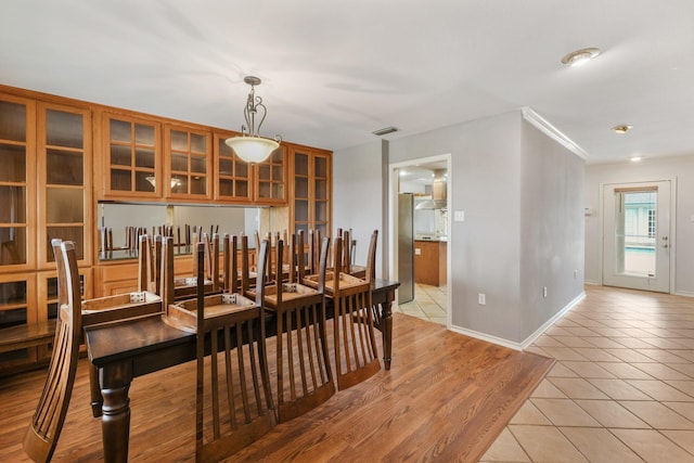 6625 E Post Rd, Kyle, TX 78640 - dining space featuring crown molding, baseboards, visible vents, and light tile patterned floors