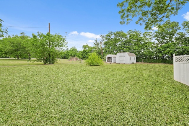 6625 E Post Rd, Kyle, TX 78640 - view of yard featuring an outdoor structure, fence, and a storage shed