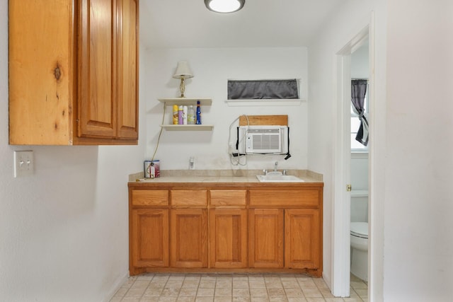 6625 E Post Rd, Kyle, TX 78640 - bathroom with a sink, cooling unit, and toilet