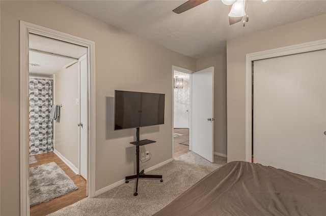 carpeted bedroom featuring a ceiling fan, baseboards, and a closet