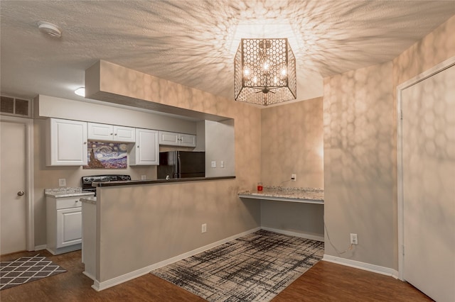 kitchen featuring visible vents, freestanding refrigerator, white cabinetry, and dark wood-style flooring