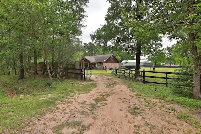 view of yard featuring fence and driveway