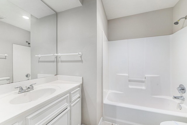 full bathroom featuring washtub / shower combination, vanity, and toilet