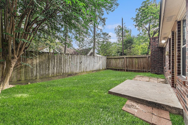 view of yard featuring a patio and a fenced backyard