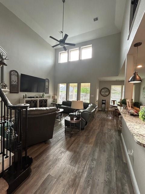 15419 Greenford Glen Dr, Cypress, TX 77429 - living area featuring plenty of natural light, a towering ceiling, ceiling fan, and dark wood-style floors