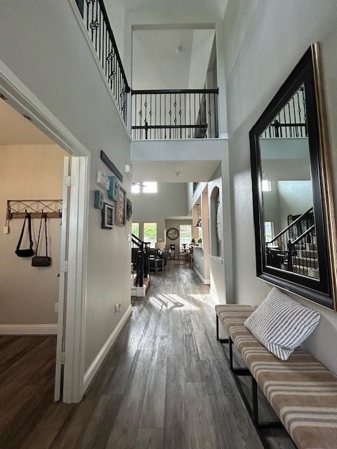 15419 Greenford Glen Dr, Cypress, TX 77429 - hall with stairs, a high ceiling, baseboards, and wood finished floors