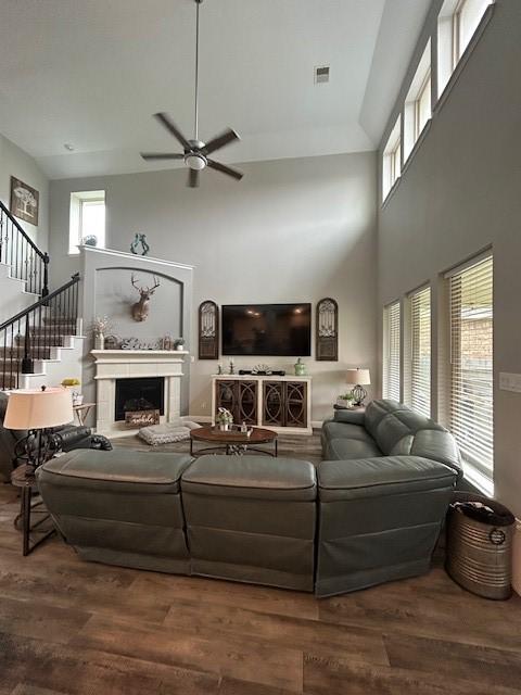 15419 Greenford Glen Dr, Cypress, TX 77429 - living room with stairway, a high ceiling, a ceiling fan, and wood finished floors