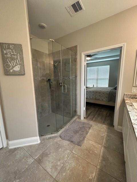 15419 Greenford Glen Dr, Cypress, TX 77429 - bathroom featuring vanity, visible vents, a shower stall, connected bathroom, and baseboards