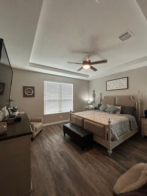 15419 Greenford Glen Dr, Cypress, TX 77429 - bedroom with visible vents, dark wood-style flooring, and a raised ceiling