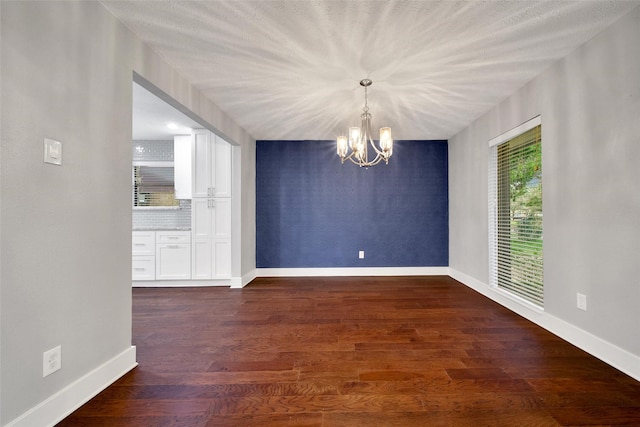 1226 Westgreen Blvd, Katy, TX 77450 - unfurnished dining area with baseboards, dark wood finished floors, and a notable chandelier