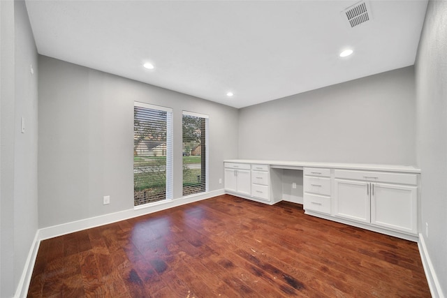 1226 Westgreen Blvd, Katy, TX 77450 - unfurnished office with baseboards, visible vents, built in desk, and dark wood-type flooring