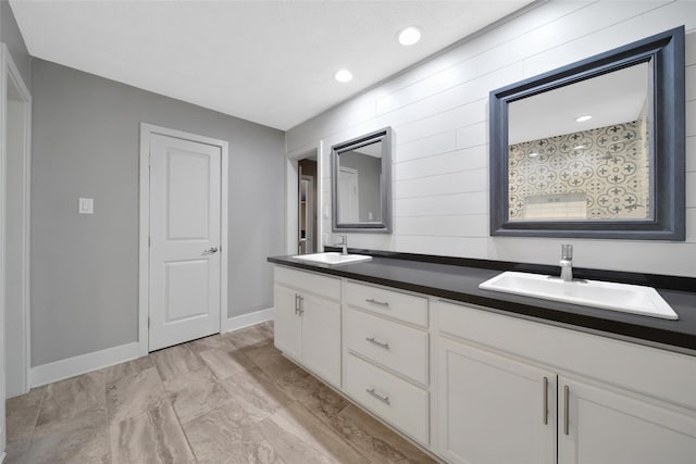 1226 Westgreen Blvd, Katy, TX 77450 - bathroom with baseboards, a sink, double vanity, and recessed lighting
