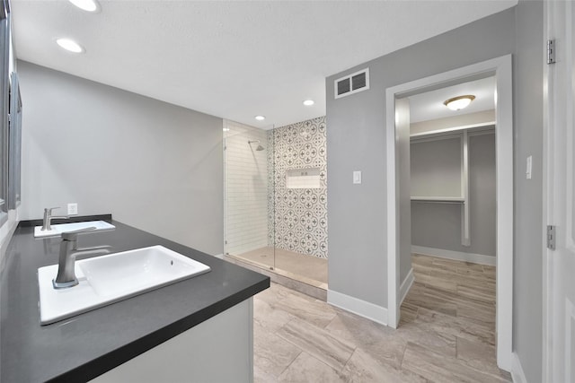 1226 Westgreen Blvd, Katy, TX 77450 - full bath featuring a sink, recessed lighting, baseboards, visible vents, and a stall shower