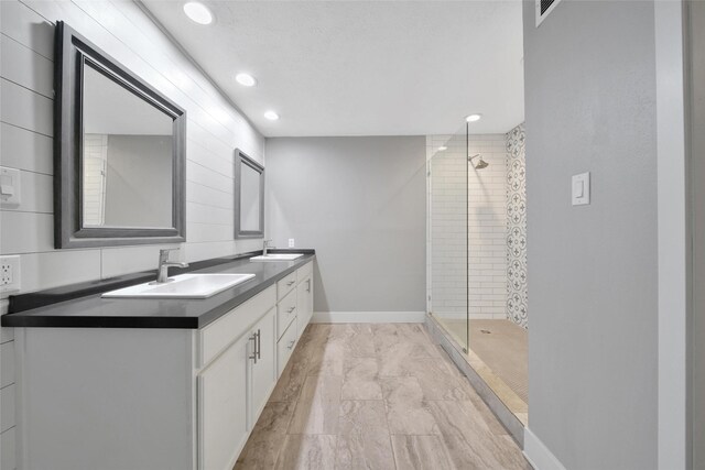 1226 Westgreen Blvd, Katy, TX 77450 - bathroom with double vanity, marble finish floor, recessed lighting, a sink, and a stall shower