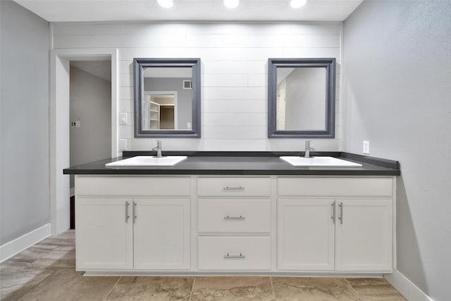 1226 Westgreen Blvd, Katy, TX 77450 - bathroom with double vanity, baseboards, visible vents, and a sink
