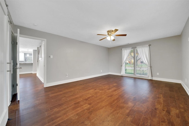 1226 Westgreen Blvd, Katy, TX 77450 - unfurnished room with dark wood-style flooring, a ceiling fan, and baseboards