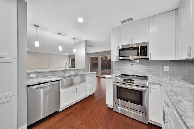 1226 Westgreen Blvd, Katy, TX 77450 - kitchen with stainless steel appliances, white cabinetry, a sink, and tasteful backsplash
