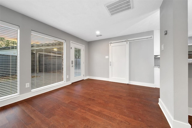 1226 Westgreen Blvd, Katy, TX 77450 - spare room featuring visible vents, wood finished floors, a barn door, baseboards, and recessed lighting