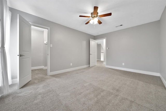 1226 Westgreen Blvd, Katy, TX 77450 - unfurnished bedroom with baseboards, light carpet, a ceiling fan, and visible vents