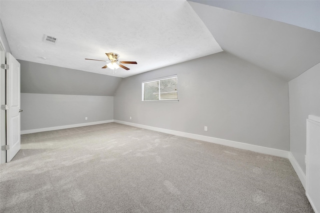 1226 Westgreen Blvd, Katy, TX 77450 - bonus room featuring a ceiling fan, baseboards, vaulted ceiling, and light colored carpet