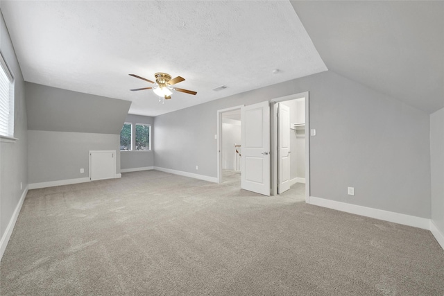1226 Westgreen Blvd, Katy, TX 77450 - additional living space featuring vaulted ceiling, a ceiling fan, light colored carpet, and visible vents