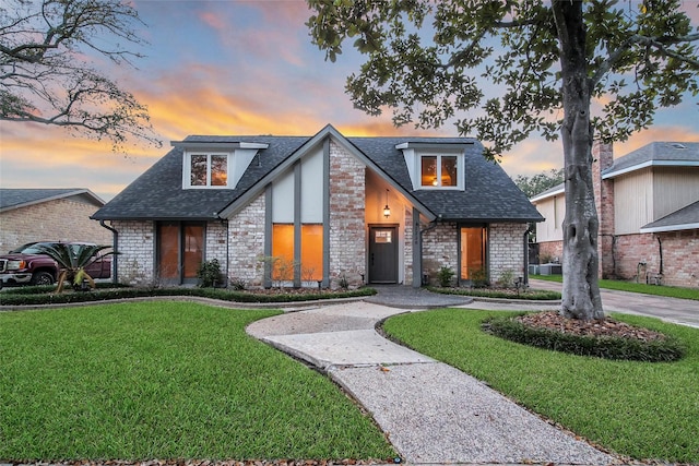 1226 Westgreen Blvd, Katy, TX 77450 - view of front of property with roof with shingles, curved driveway, a yard, and stone siding