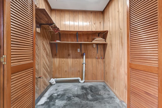 washroom with wooden walls and laundry area