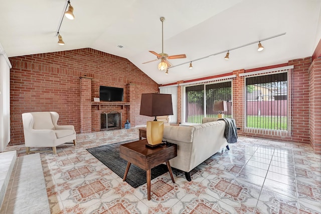 living room with track lighting, brick wall, and lofted ceiling