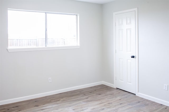 1222 Lynn Ln, Humble, TX 77338 - spare room with baseboards and wood finished floors