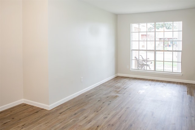 1222 Lynn Ln, Humble, TX 77338 - empty room featuring baseboards and wood finished floors