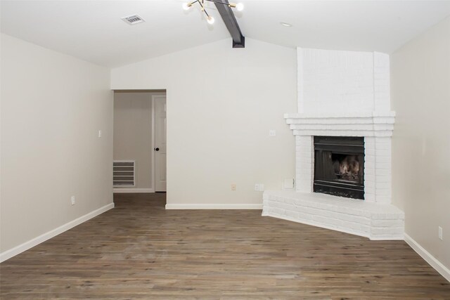 1222 Lynn Ln, Humble, TX 77338 - unfurnished living room with visible vents, a brick fireplace, wood finished floors, baseboards, and vaulted ceiling with beams