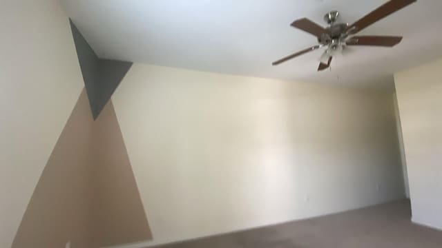 spare room with a ceiling fan