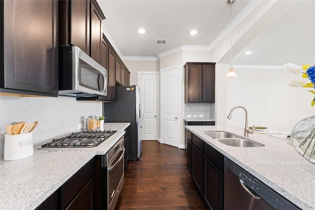 kitchen featuring visible vents, ornamental molding, dark wood-style flooring, a sink, and stainless steel appliances