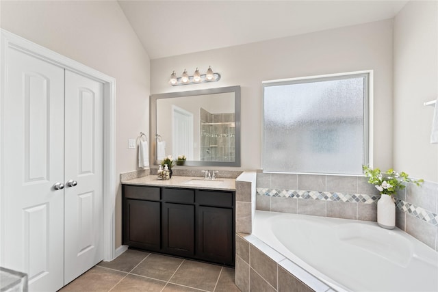 bathroom featuring tile patterned floors, a shower stall, a garden tub, and vanity