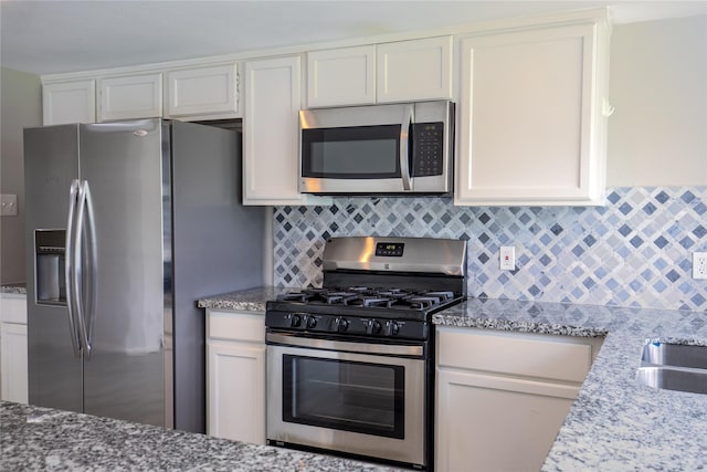 11306 Chiselhurst Way Ct, Houston, TX 77065 - kitchen featuring white cabinetry, appliances with stainless steel finishes, backsplash, and light stone countertops