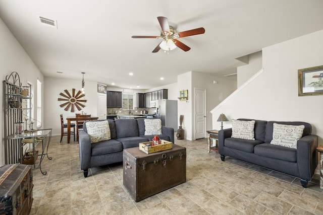 living room featuring visible vents, a ceiling fan, stairs, and recessed lighting
