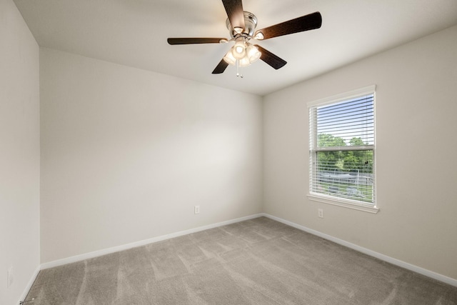 unfurnished room featuring a ceiling fan, baseboards, and light colored carpet