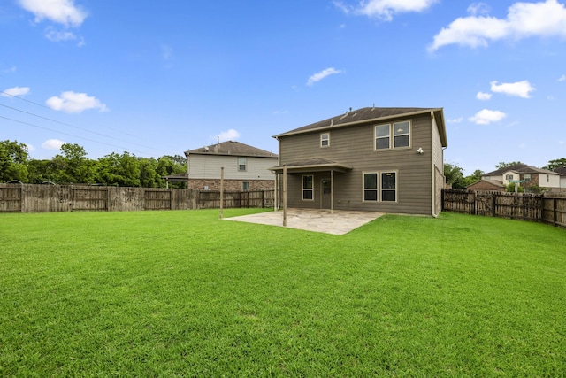 rear view of property featuring a fenced backyard, a yard, and a patio area