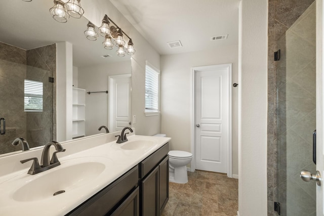 full bathroom featuring visible vents, a sink, a stall shower, and a wealth of natural light