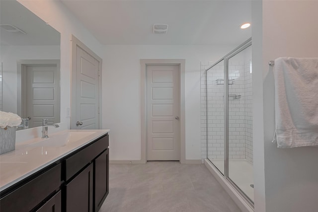 full bathroom with double vanity, tile patterned floors, a sink, and a stall shower